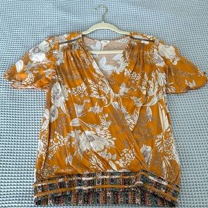 Anthropologie Floral Print wrap top with flutter sleeve, size M.